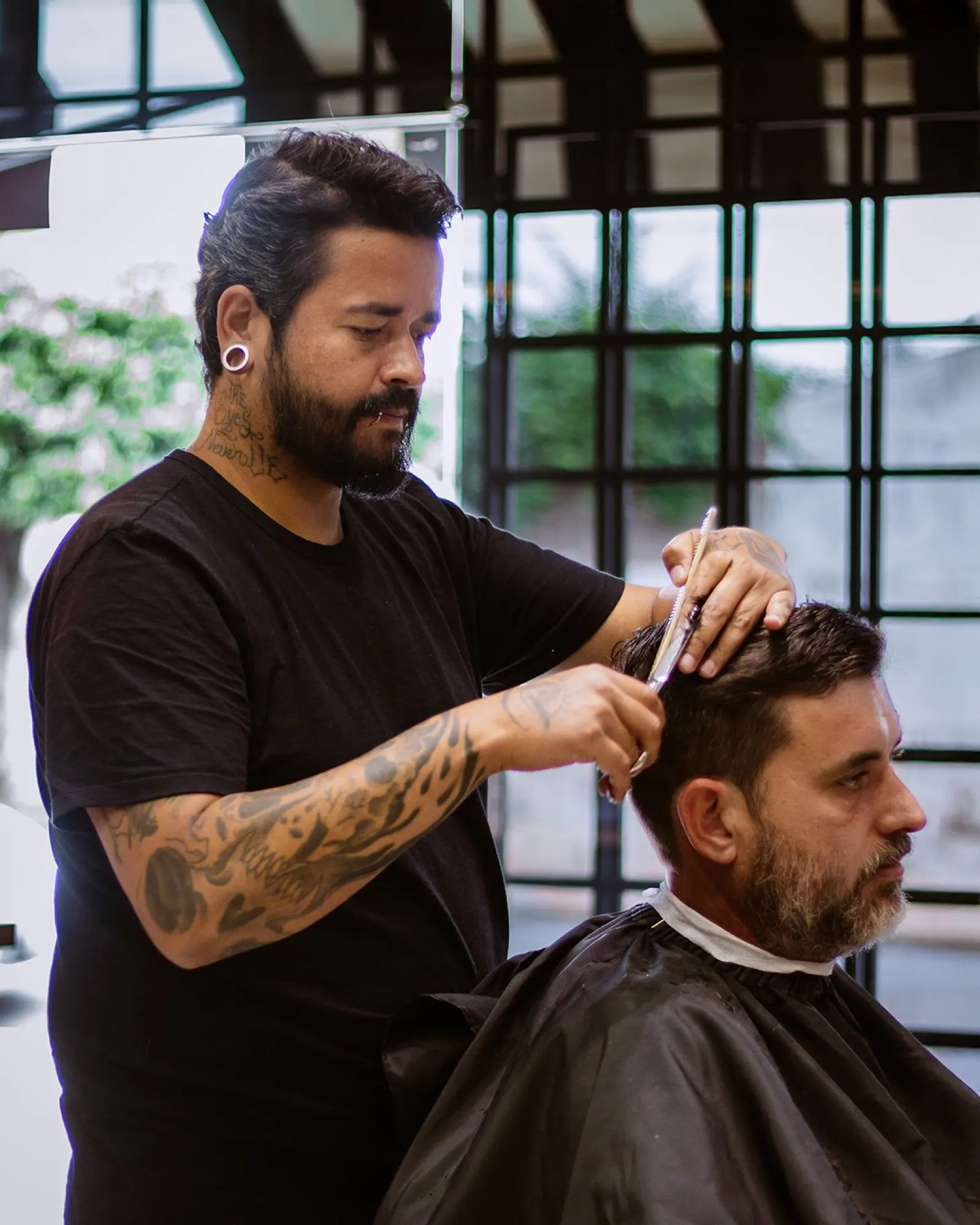 Barbeiro cortando o cabelo de um cliente na Tresor
